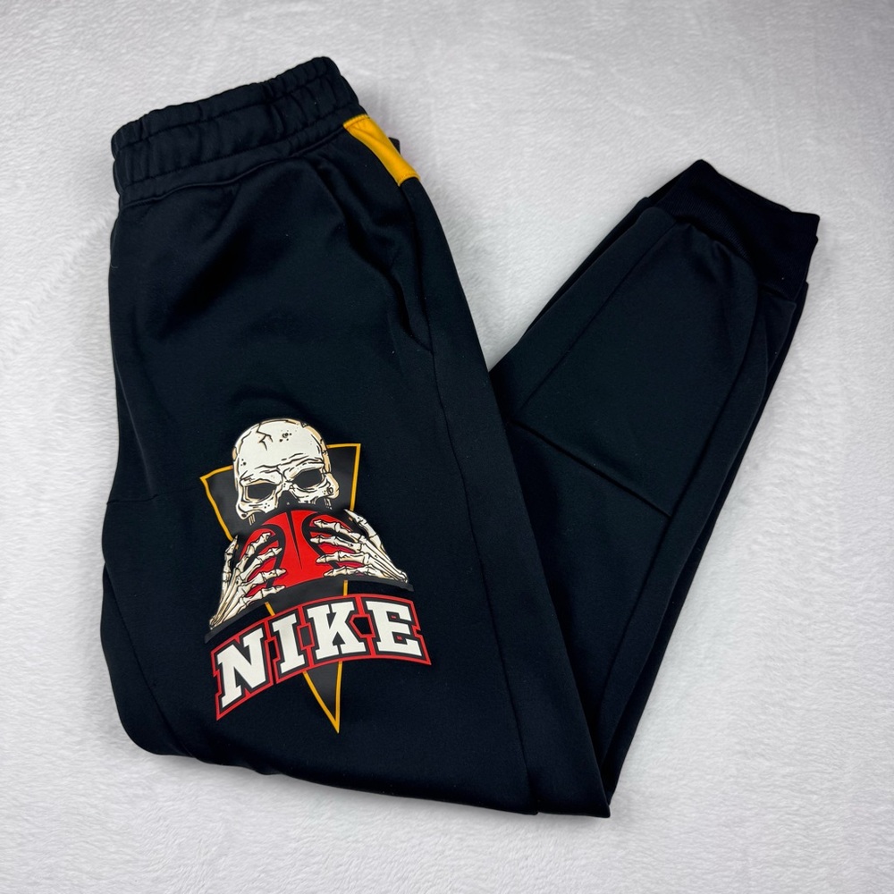 Nike Frenzy Joggers Men's Pants in black, orange, and yellow a skull DR9820-010